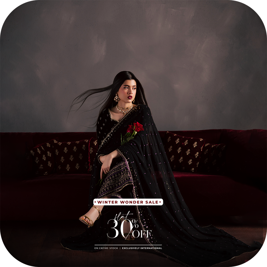 A BATIK luxury pret festive outfit crafted in georgette, chiffon, velvet, raw silk, or organza, photographed in soft evening light to highlight elegant movement, South Asian craftsmanship, and UAE inspired styling.