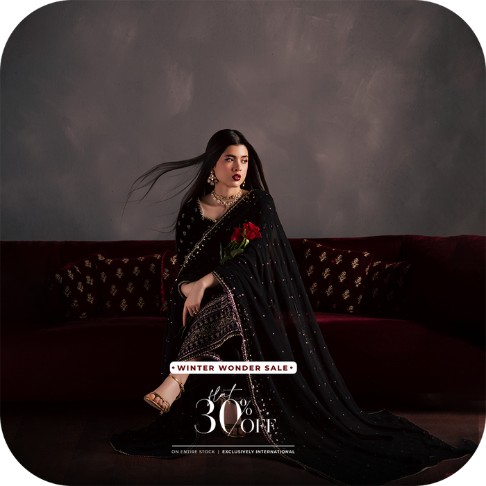 A BATIK luxury pret festive outfit crafted in georgette, chiffon, velvet, raw silk, or organza, photographed in soft evening light to highlight elegant movement, South Asian craftsmanship, and UAE inspired styling.