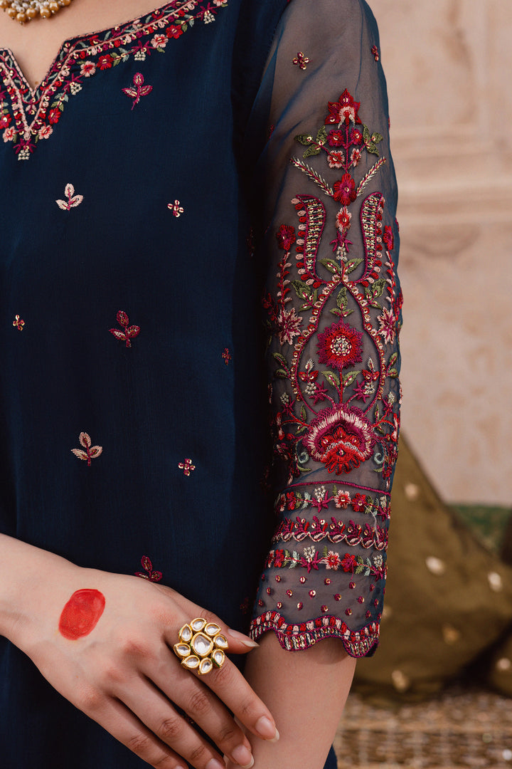 Batik UAE Aleysa three piece raw silk set featuring an embroidered short shirt with kaviya finishing organza sleeves flared embroidered sharara and printed organza dupatta with sequin spread. Affordable ethnic South Asian Desi Indian Pakistani designer wear UAE fashion for teens adults girls and women available in sizes  S M L festive eid 