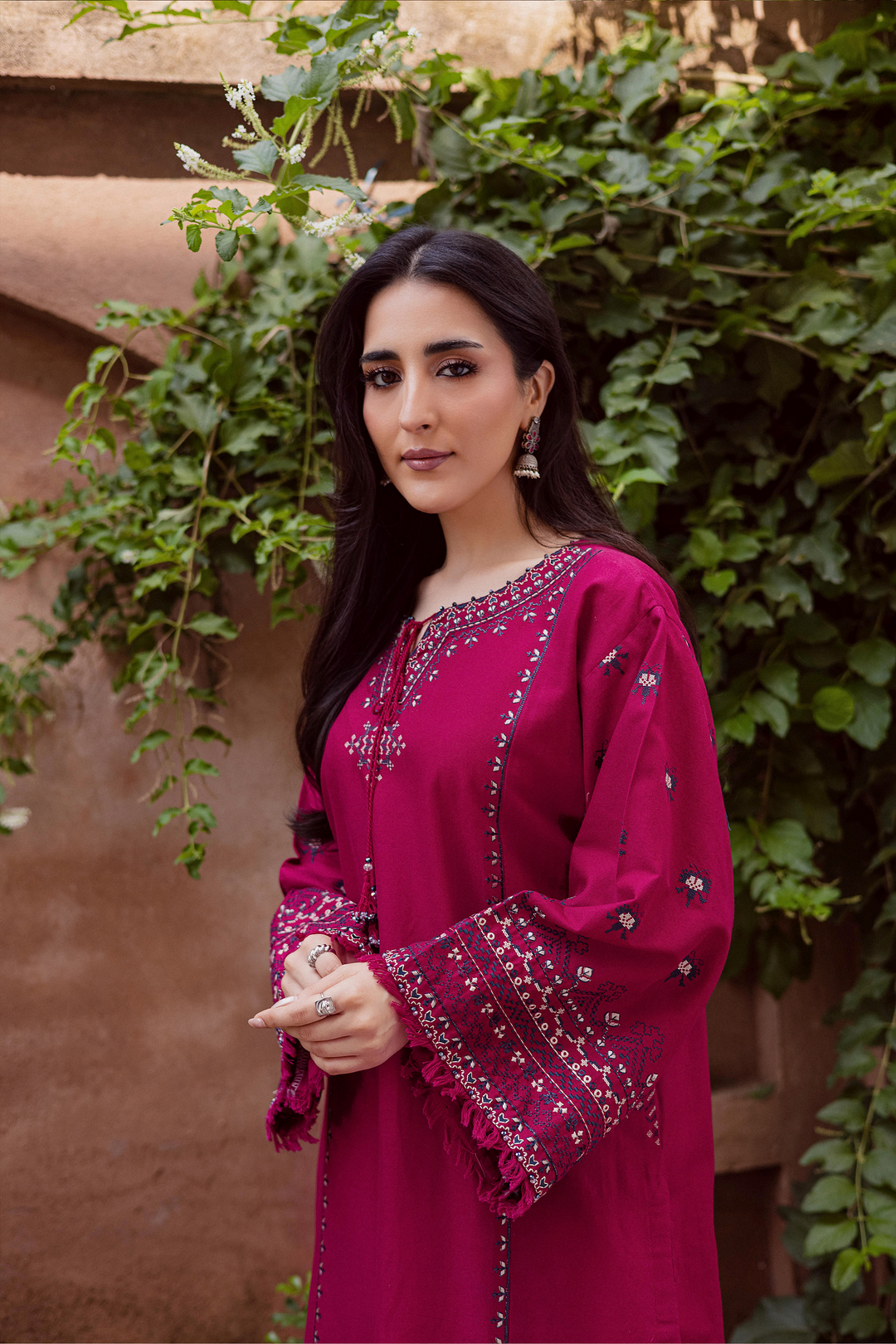 Batik UAE Crossword two piece khaddar set featuring a paneled shirt with cross stitch embroidery, tassel neckline, and fringed sleeves. Affordable ethnic South Asian Desi Indian Pakistani designer wear UAE fashion for teens, adults, girls, and women.