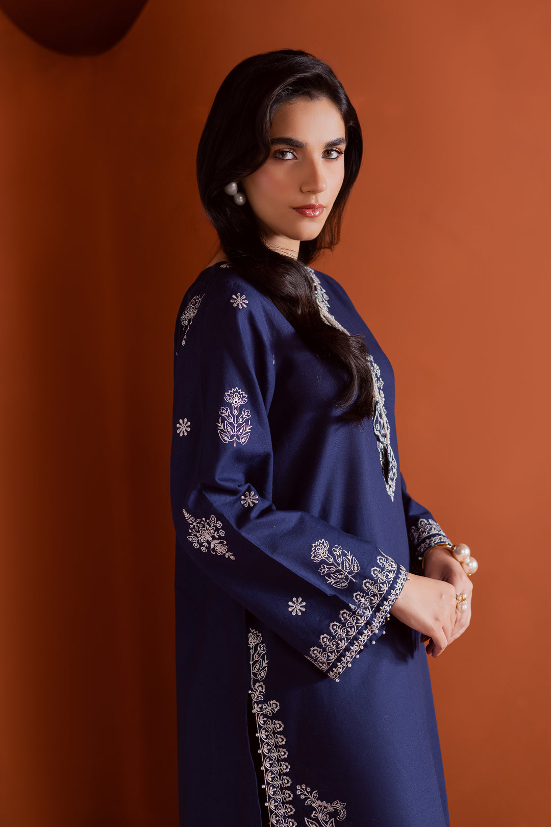 Radiate effortless charm with the Bloom two-piece set, featuring a beautifully composed embroidered midnight blue khaddar shirt that brings elegance due to every detail. The neckline is accented with delicate embroidered tassels, adding a playful yet refined touch.

Paired with matching khaddar culottes, this ensemble offers a graceful and modern silhouette—perfect for daytime festivities or casual gatherings.