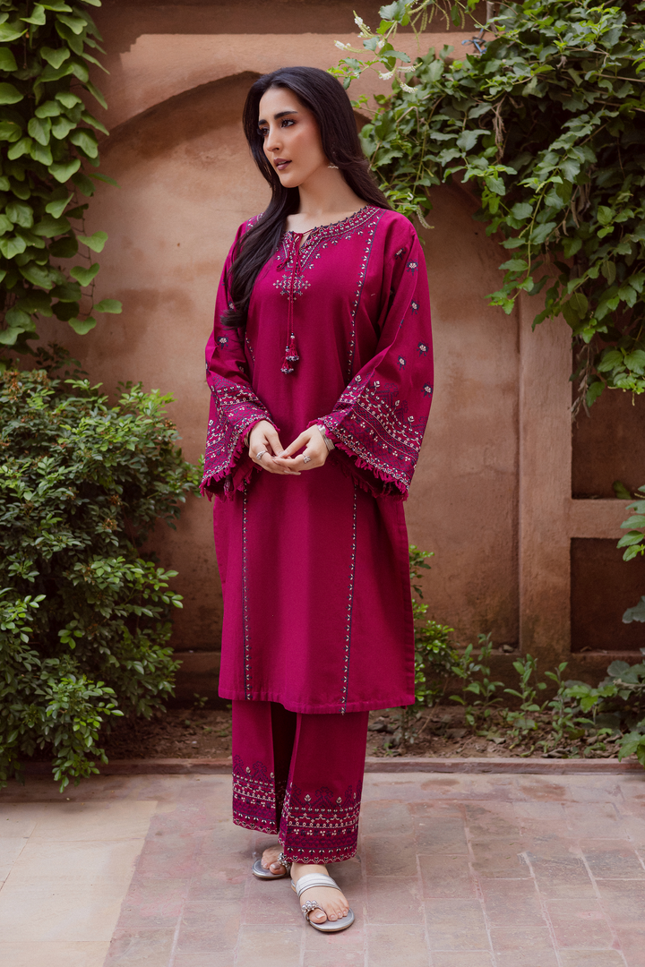 Batik UAE Crossword two piece khaddar set featuring a paneled shirt with cross stitch embroidery, tassel neckline, and fringed sleeves. Affordable ethnic South Asian Desi Indian Pakistani designer wear UAE fashion for teens, adults, girls, and women.