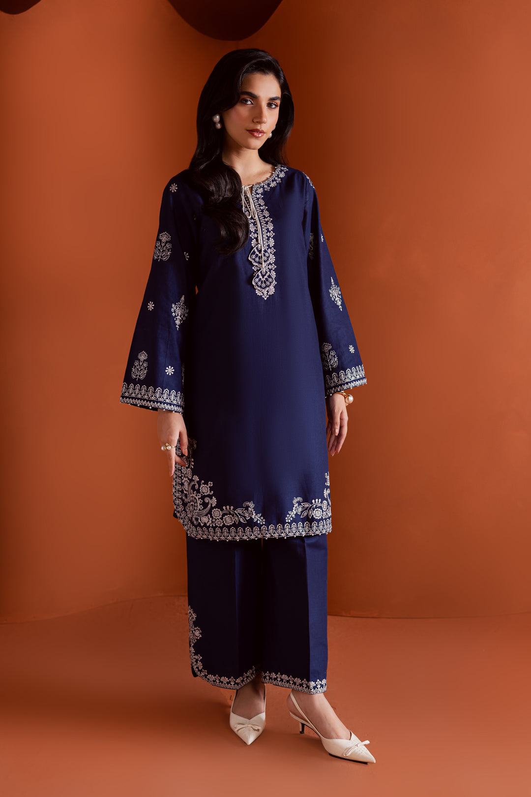 Radiate effortless charm with the Bloom two-piece set, featuring a beautifully composed embroidered midnight blue khaddar shirt that brings elegance due to every detail. The neckline is accented with delicate embroidered tassels, adding a playful yet refined touch.

Paired with matching khaddar culottes, this ensemble offers a graceful and modern silhouette—perfect for daytime festivities or casual gatherings.