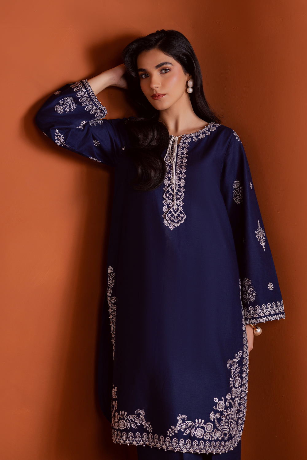 Radiate effortless charm with the Bloom two-piece set, featuring a beautifully composed embroidered midnight blue khaddar shirt that brings elegance due to every detail. The neckline is accented with delicate embroidered tassels, adding a playful yet refined touch.

Paired with matching khaddar culottes, this ensemble offers a graceful and modern silhouette—perfect for daytime festivities or casual gatherings.