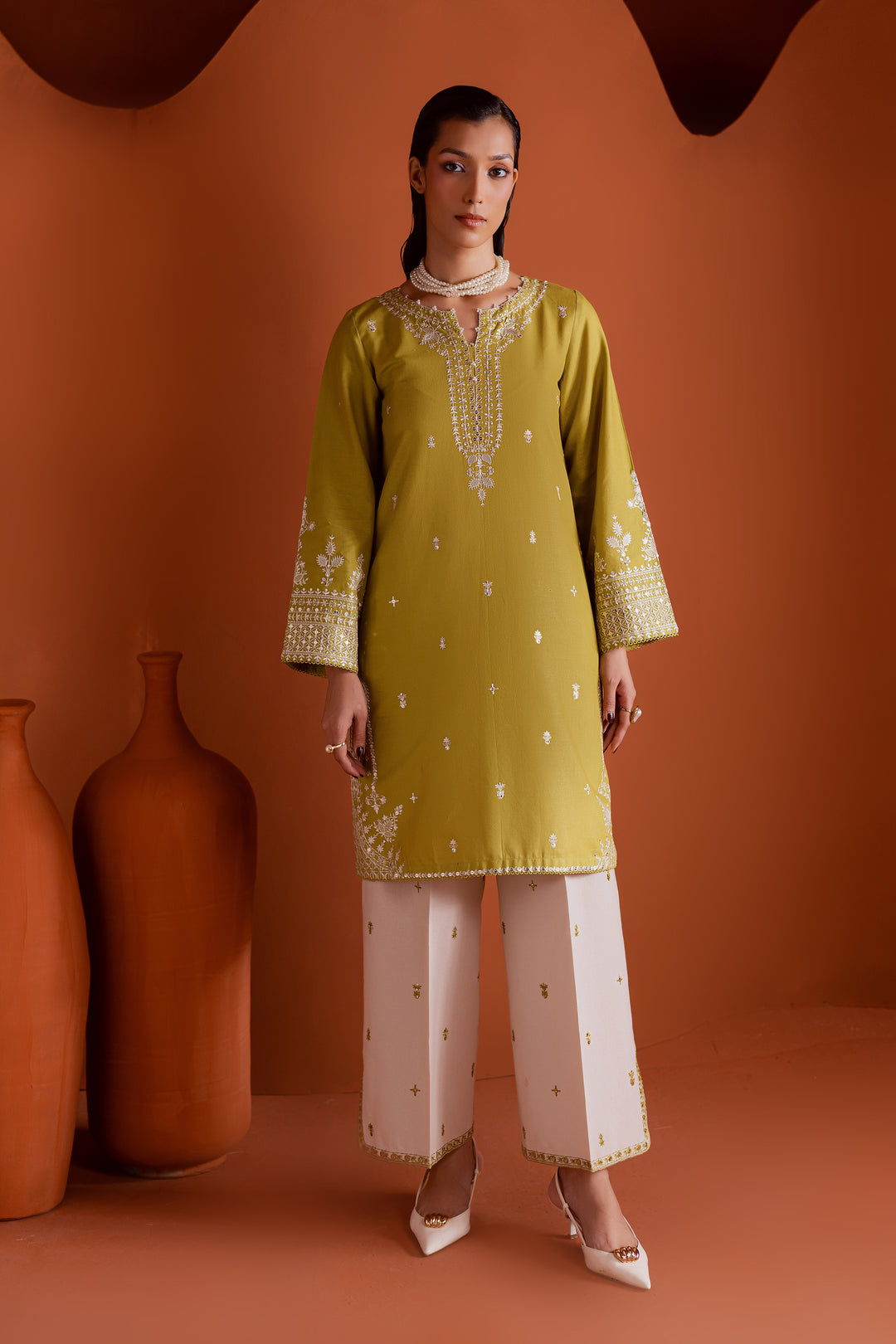 Pear green embroidered khaddar 2-piece dress with sequin detailing and pearl neckline, styled for modern festive wear