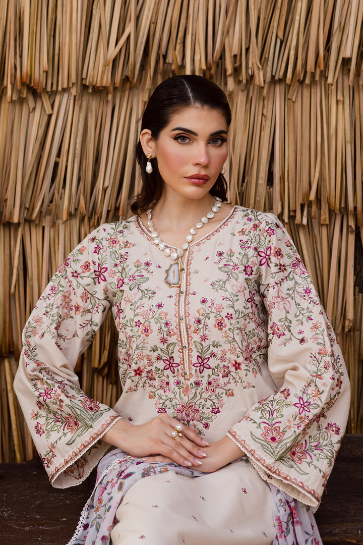 Close-up of hand-embellished neckline on beige khaddar shirt with floral embroidery, showcasing premium Pakistani craftsmanship