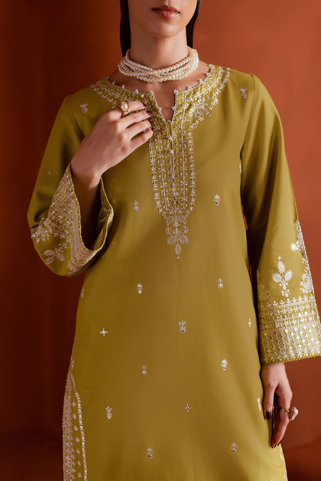 Contemporary pear green khaddar outfit with minimal lace and elegant embroidery, perfect for modern women seeking affordable festive fashion