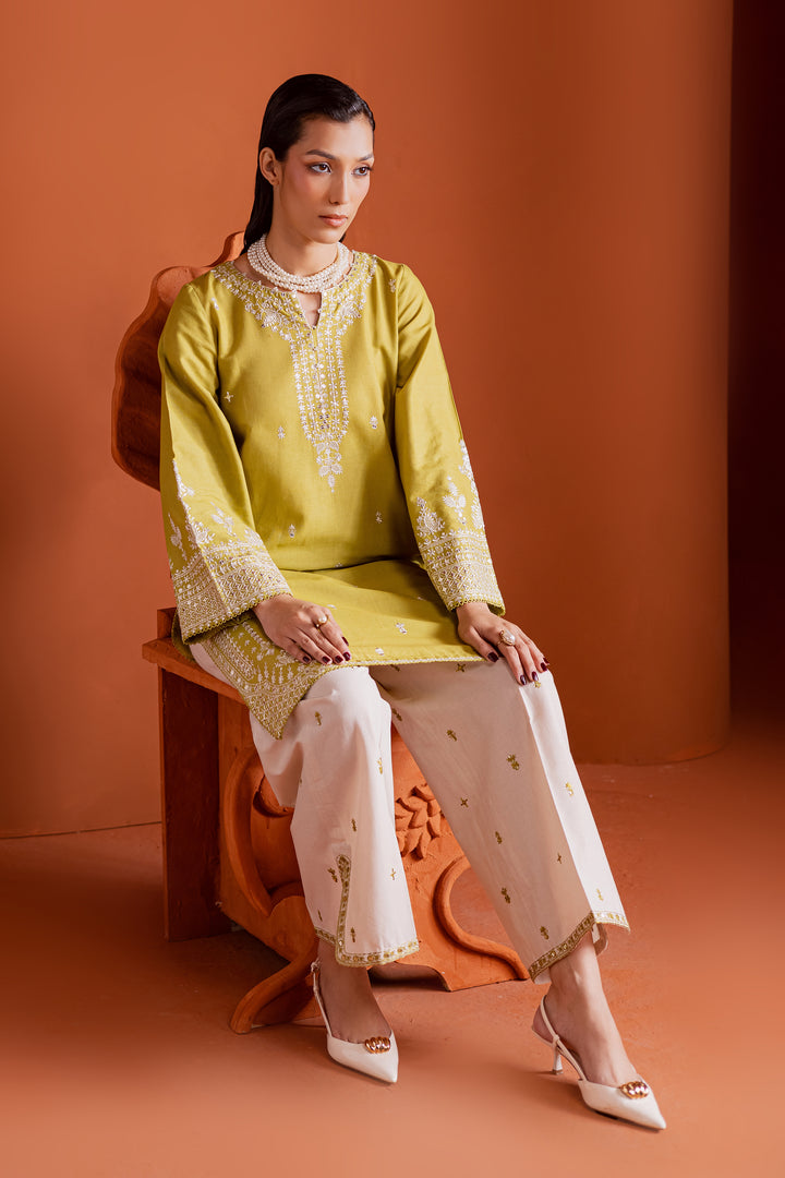 Short pear green khaddar shirt paired with white slit culottes, a chic Pakistani outfit that’s elegant, versatile, and affordably priced