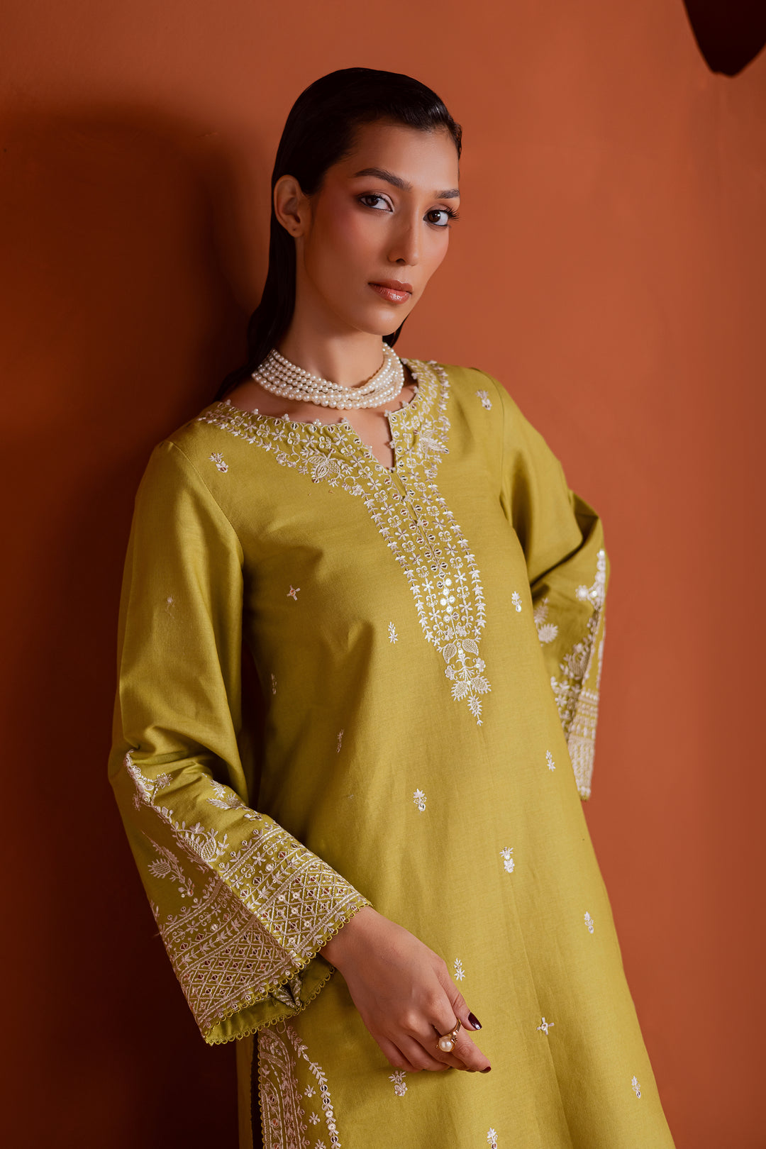 Affordable pear green khaddar dress featuring intricate embroidery and pearl accents, available with fast delivery across UAE and globally