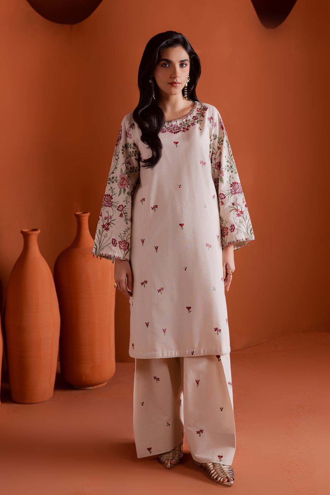 Beige embroidered khaddar two piece suit with floral sleeves and neckline. Elegant Pakistani ready to wear outfit perfect for festive and casual gatherings