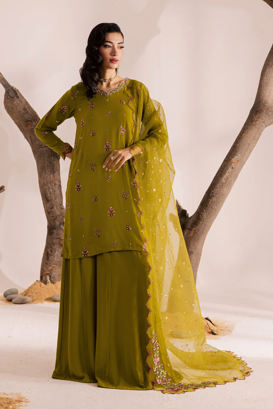 Close-up of olive-green embroidered khaddar fabric featuring fine floral threadwork, lace finishing, and sequin highlights. Part of Batik’s Pakistani ethnic wear collection for women, crafted with care and delivered globally