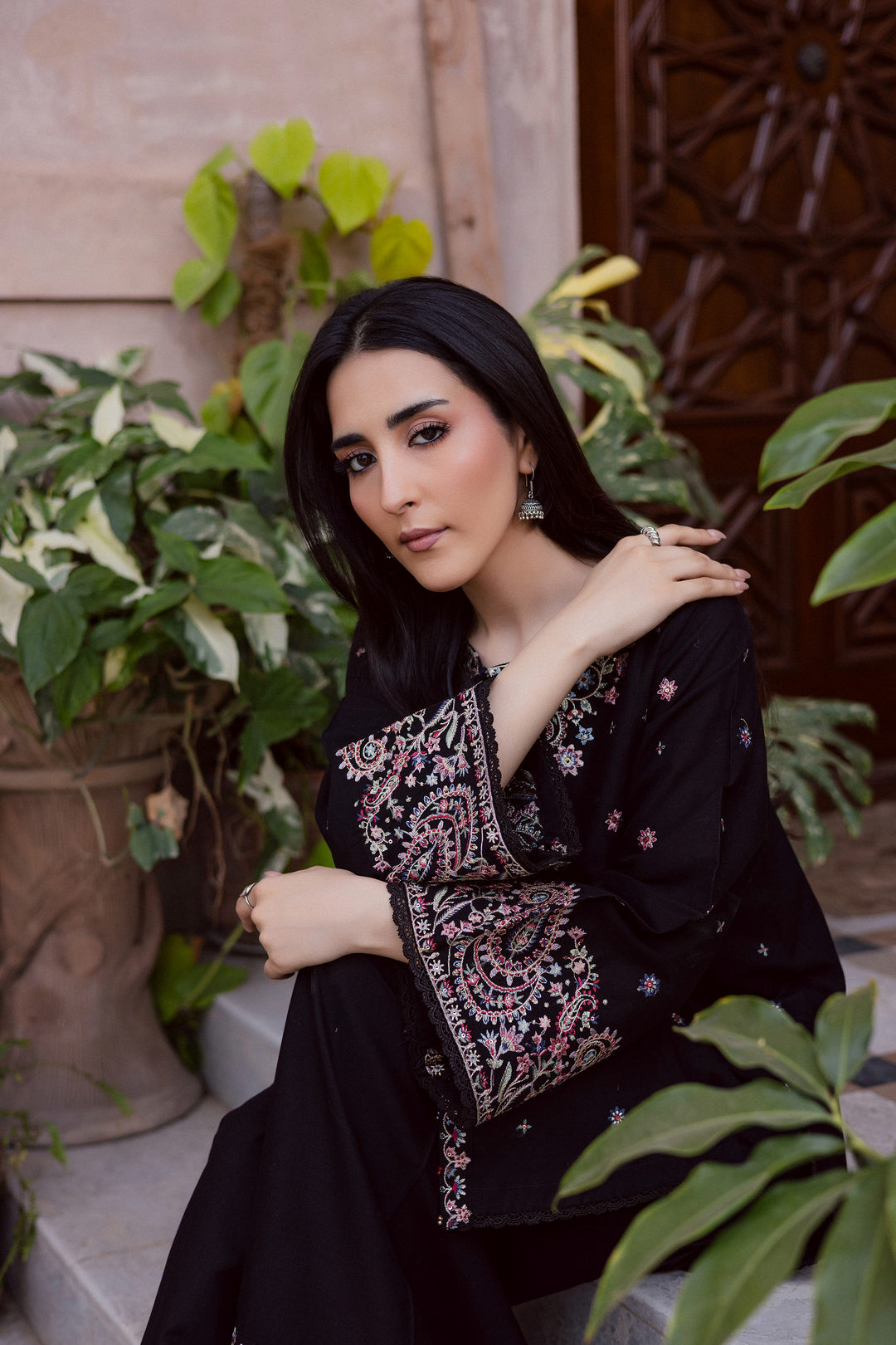 Black embroidered khaddar kurta for women featuring intricate floral embroidery and handcrafted tassel details. Perfect South Asian ethnic outfit for festive gatherings or traditional wear