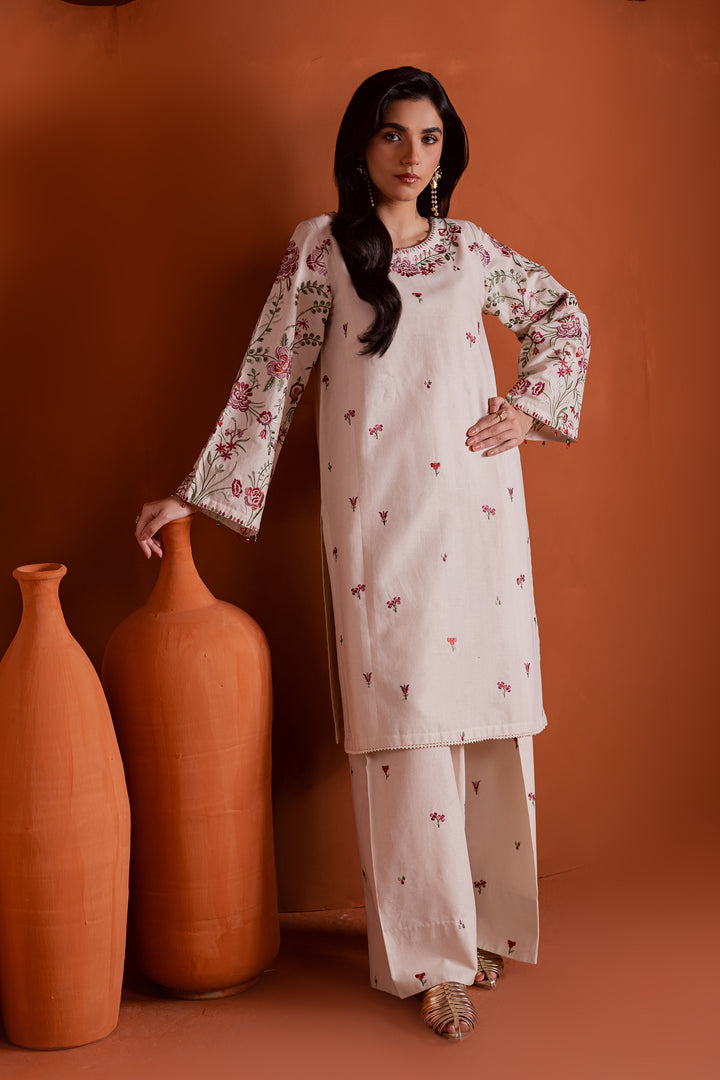 Beige embroidered two piece khaddar set featuring detailed sleeves and shalwar embroidery. Pakistani clothing brand offering global delivery