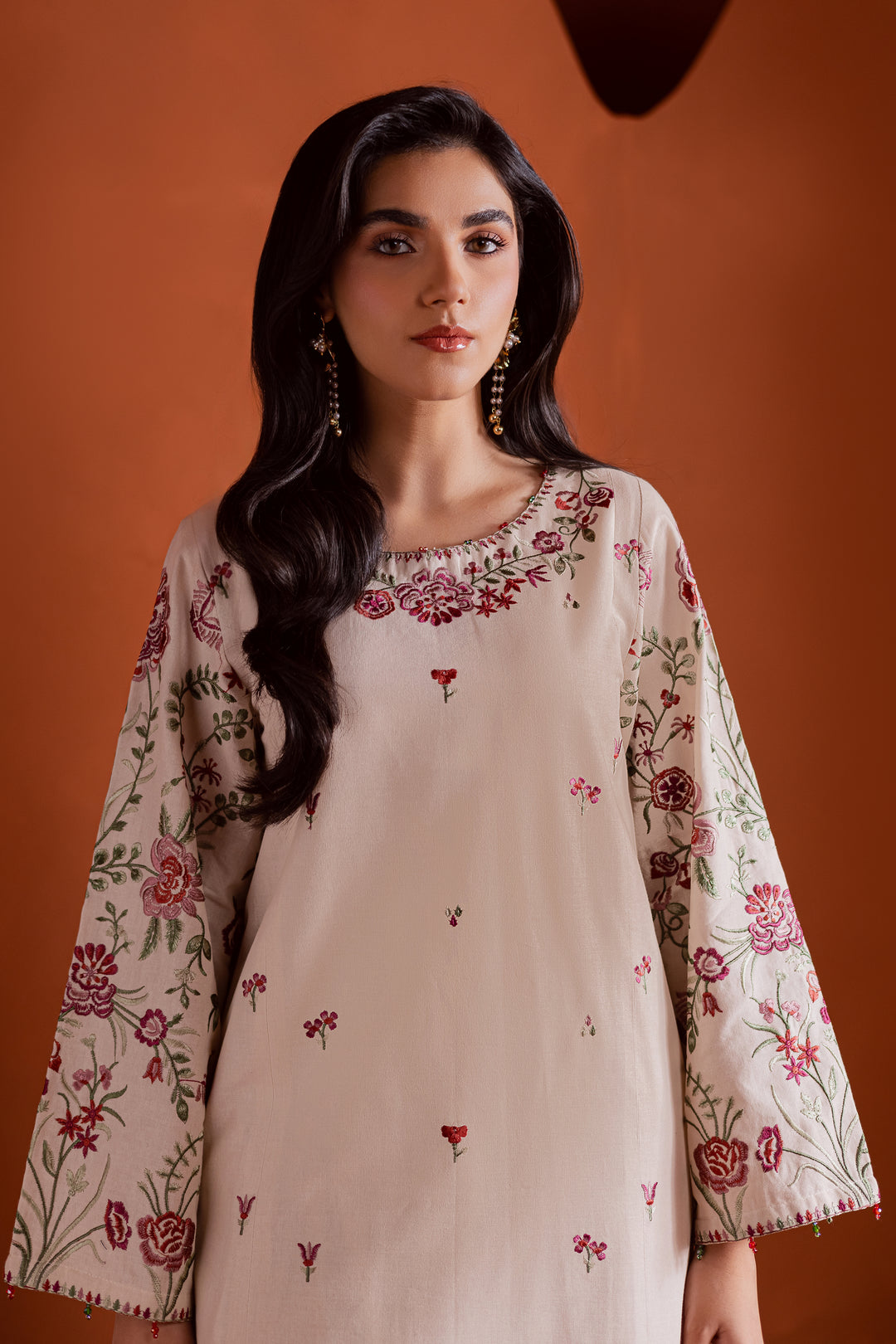 Intricately embroidered neckline with floral patterns on beige khaddar fabric. Premium Pakistani ethnic wear for women online in UAE