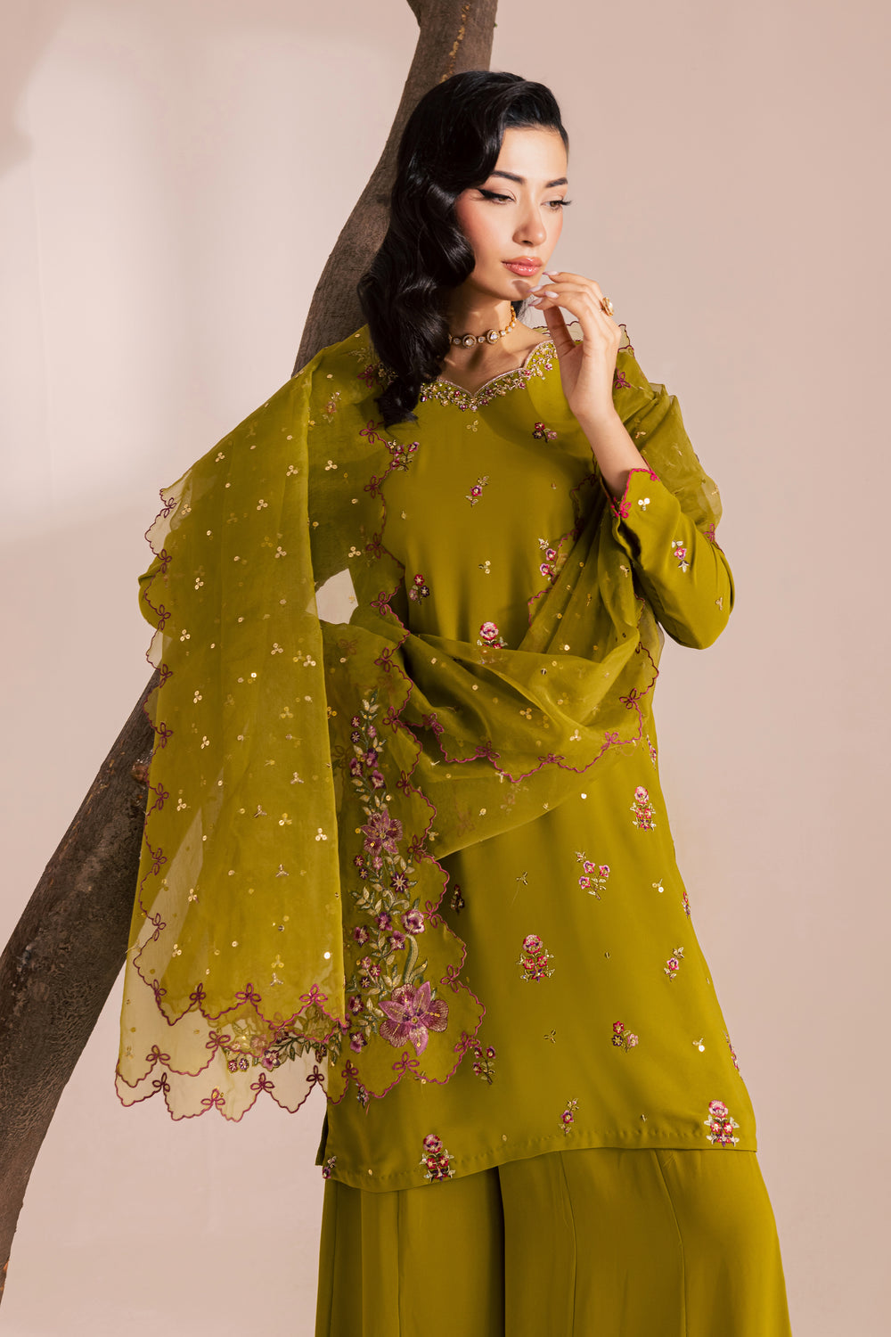 Olive green Pakistani embroidered outfit for women with floral embellishments and scalloped chiffon dupatta. Affordable festive ethnic wear by Batik, shipping internationally