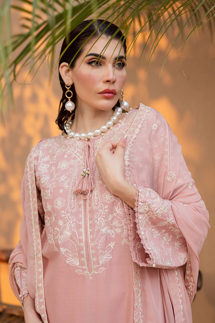 Close-up of embroidered neckline and tassel details on taffy pink khaddar shirt showcasing refined South Asian craftsmanship