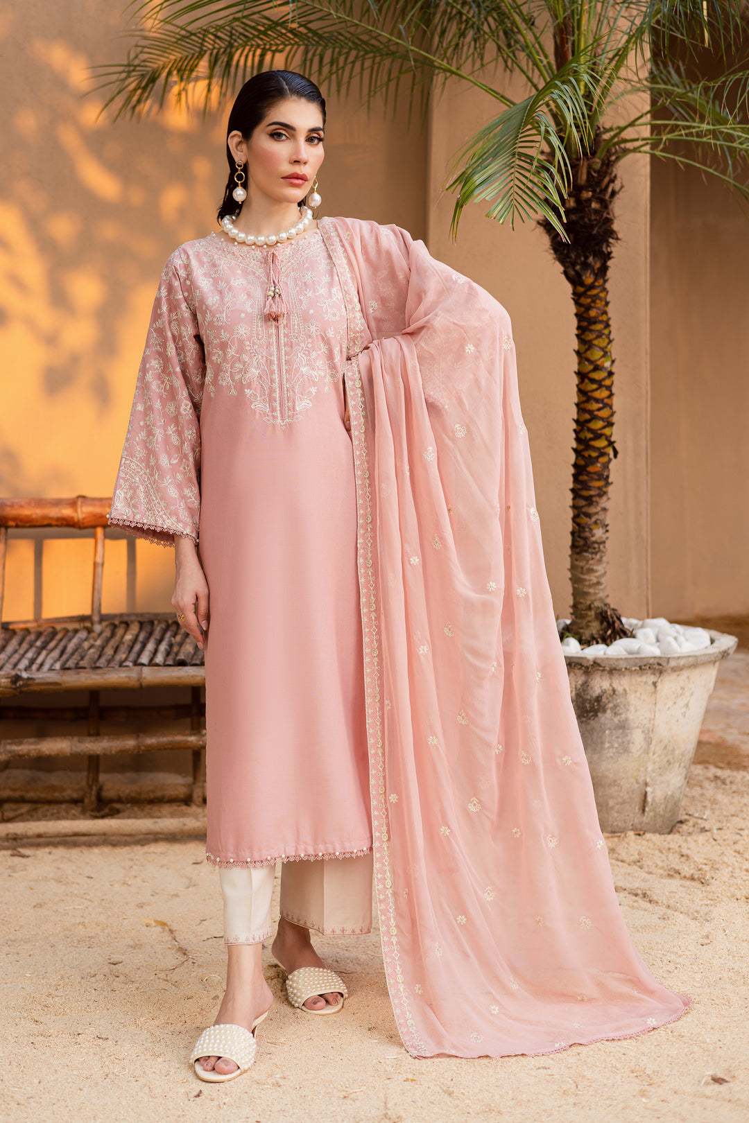 Taffy pink embroidered khaddar 3-piece dress with lace and tassel detailing, styled with an off-white embroidered trouser and crinkle dupatta