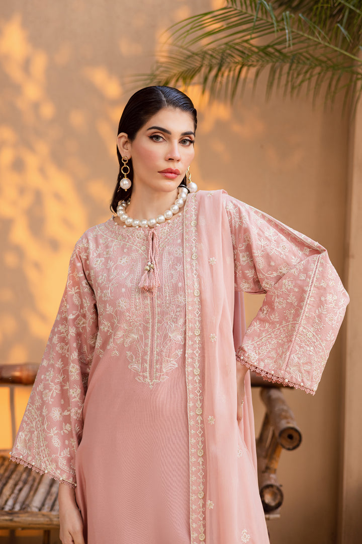 Light pink khaddar shirt with delicate embroidery and tassels styled with an embroidered crinkle dupatta for effortless elegance