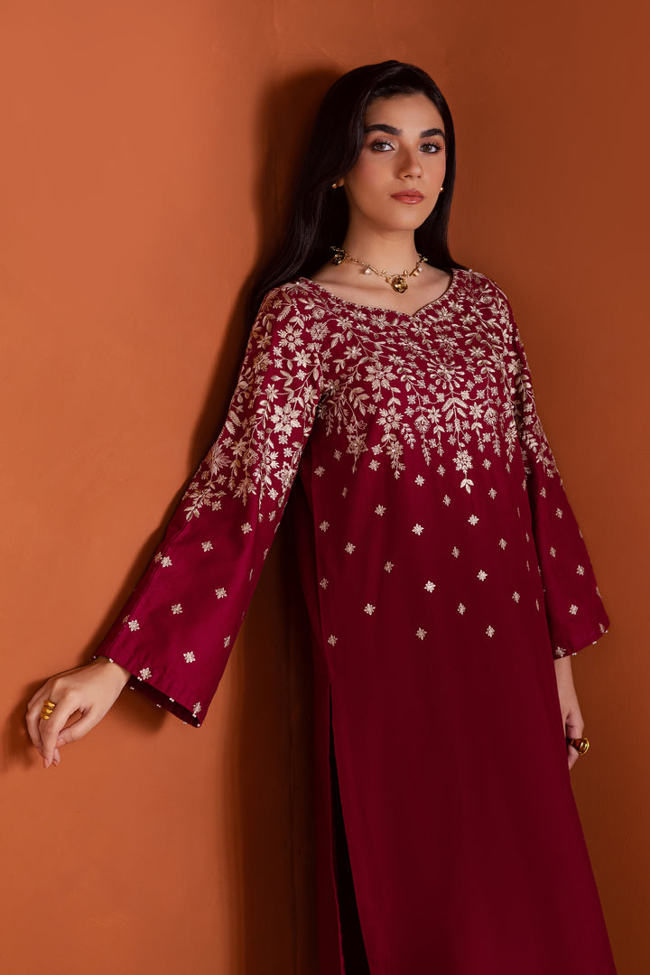 Pakistani ethnic two piece khaddar set in cherry raspberry pink adorned with pearls and fringe detailing for festive elegance