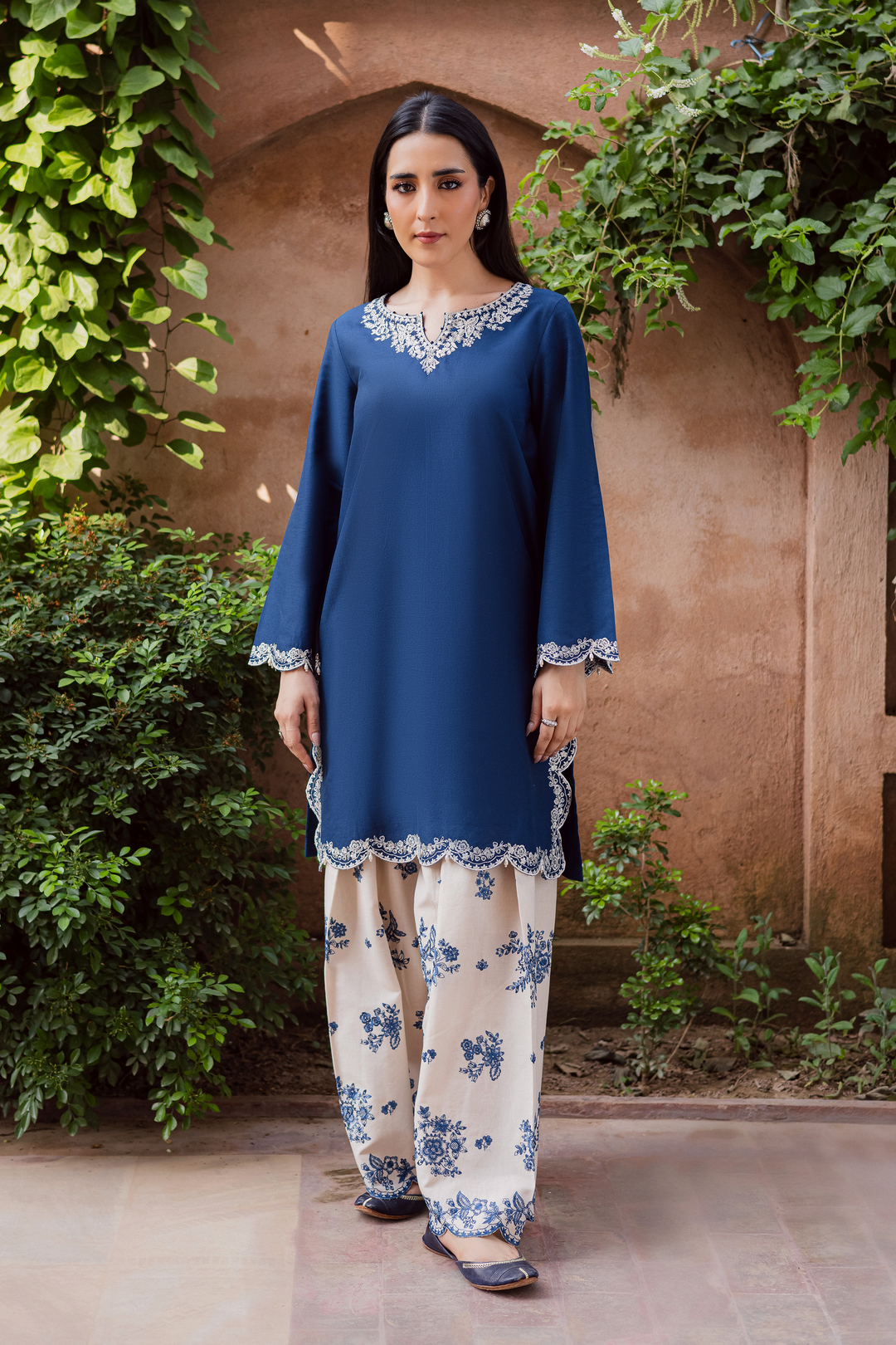 Batik UAE two piece khaddar set featuring a short straight embroidered shirt with scalloped borders keyhole neckline and pearl embellished sleeves paired with a fully embroidered contrasting shalwar. Affordable ethnic South Asian Desi Indian Pakistani designer wear UAE fashion for teens adults girls and women available in sizes XS S M L XL blue white