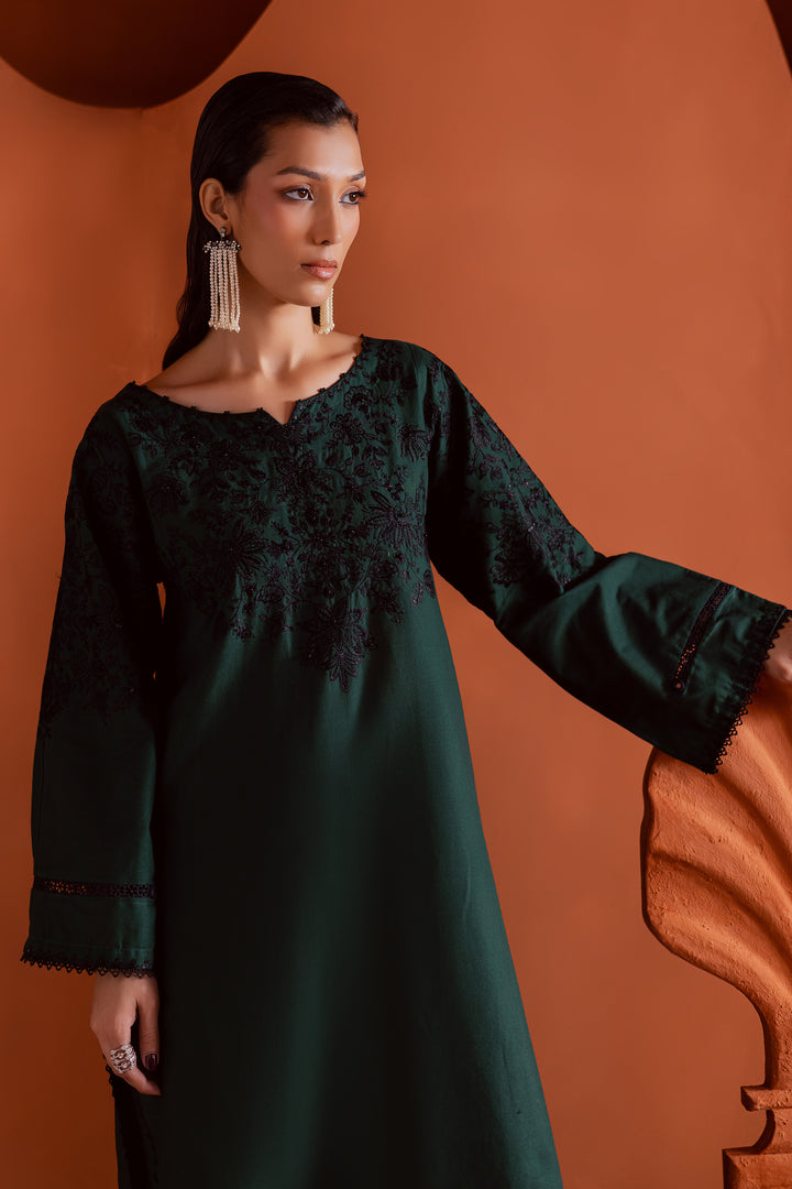 Side profile of embroidered emerald green khaddar kurta and shalwar set — traditional South Asian outfit with modern elegance, ideal for festive and semi-formal gatherings