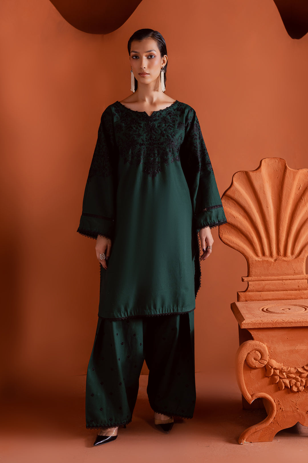Emerald green khaddar 2-piece suit with contrast black embroidery and hand-embellished neckline - elegant Pakistani festive wear for women, ready to wear with worldwide delivery.