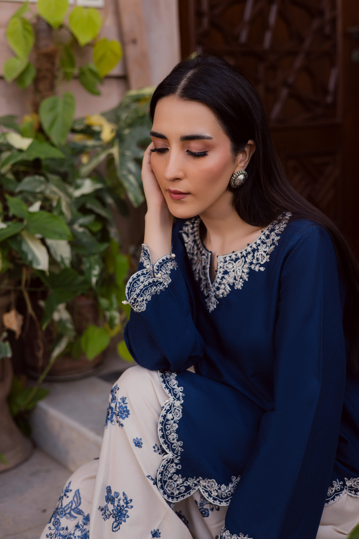 Indian Batik UAE two piece khaddar set featuring a short straight embroidered shirt with scalloped borders keyhole neckline and pearl embellished sleeves paired with a fully embroidered contrasting shalwar. Affordable ethnic South Asian Desi Indian Pakistani designer wear UAE fashion for teens adults girls and women available in sizes XS S M L XL blue white