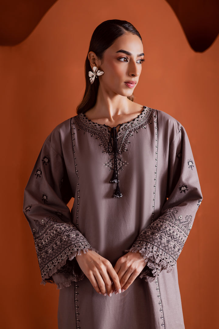Batik UAE Crossword two piece khaddar set featuring a drop shoulder paneled shirt with cross stitch embroidery tassel neckline and fringed sleeves. Affordable ethnic South Asian Desi Indian Pakistani designer wear UAE fashion for teens adults girls and women.