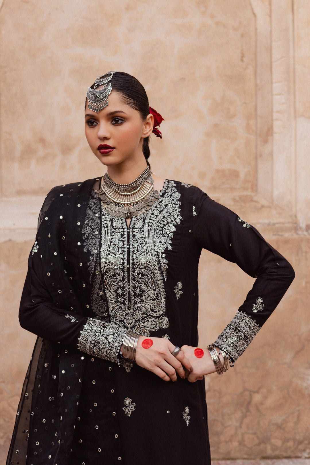 Batik UAE Arbish three piece black raw silk set featuring an embroidered paneled short shirt with crystal detailing paired with an embroidered raw silk sharara and organza dupatta. Affordable ethnic South Asian Desi Indian Pakistani designer wear UAE fashion for teens adults girls and women available in sizes XS S M L XL.