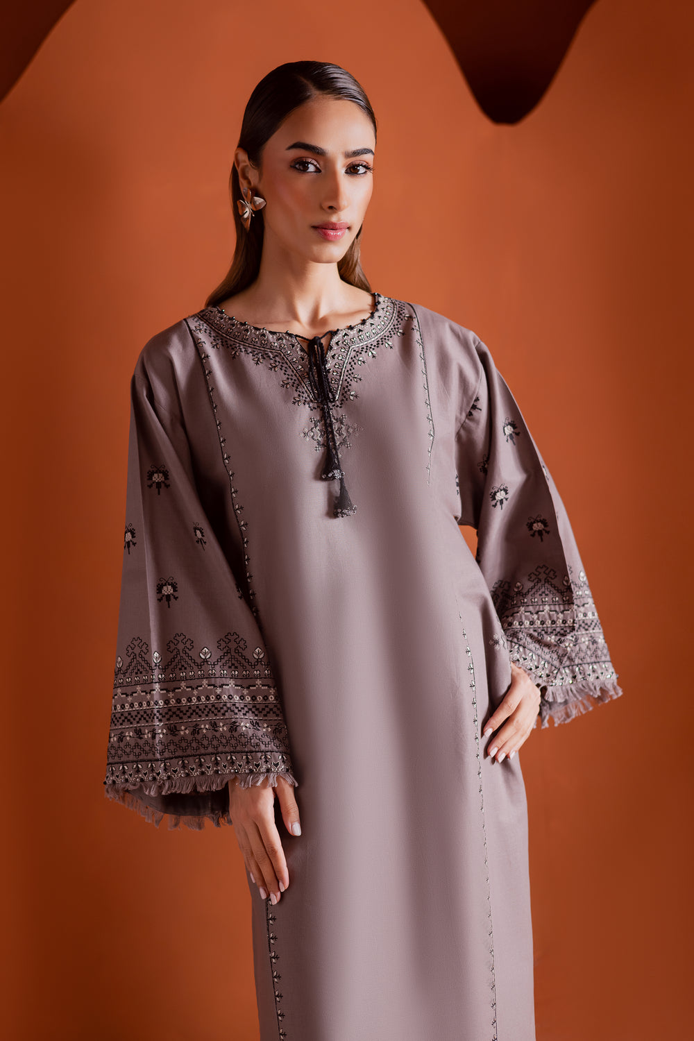 Batik UAE Crossword two piece khaddar set featuring a drop shoulder paneled shirt with cross stitch embroidery tassel neckline and fringed sleeves. Affordable ethnic South Asian Desi Indian Pakistani designer wear UAE fashion for teens adults girls and women.