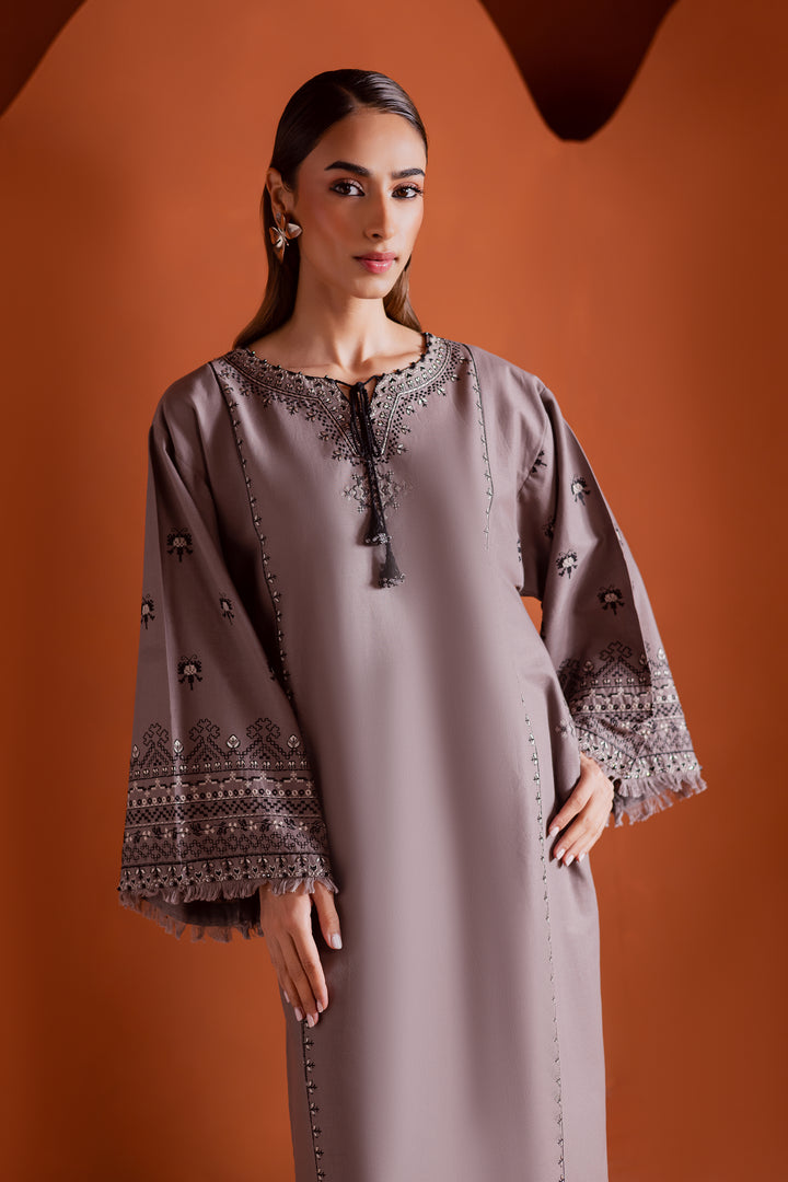 Batik UAE Crossword two piece khaddar set featuring a drop shoulder paneled shirt with cross stitch embroidery tassel neckline and fringed sleeves. Affordable ethnic South Asian Desi Indian Pakistani designer wear UAE fashion for teens adults girls and women.