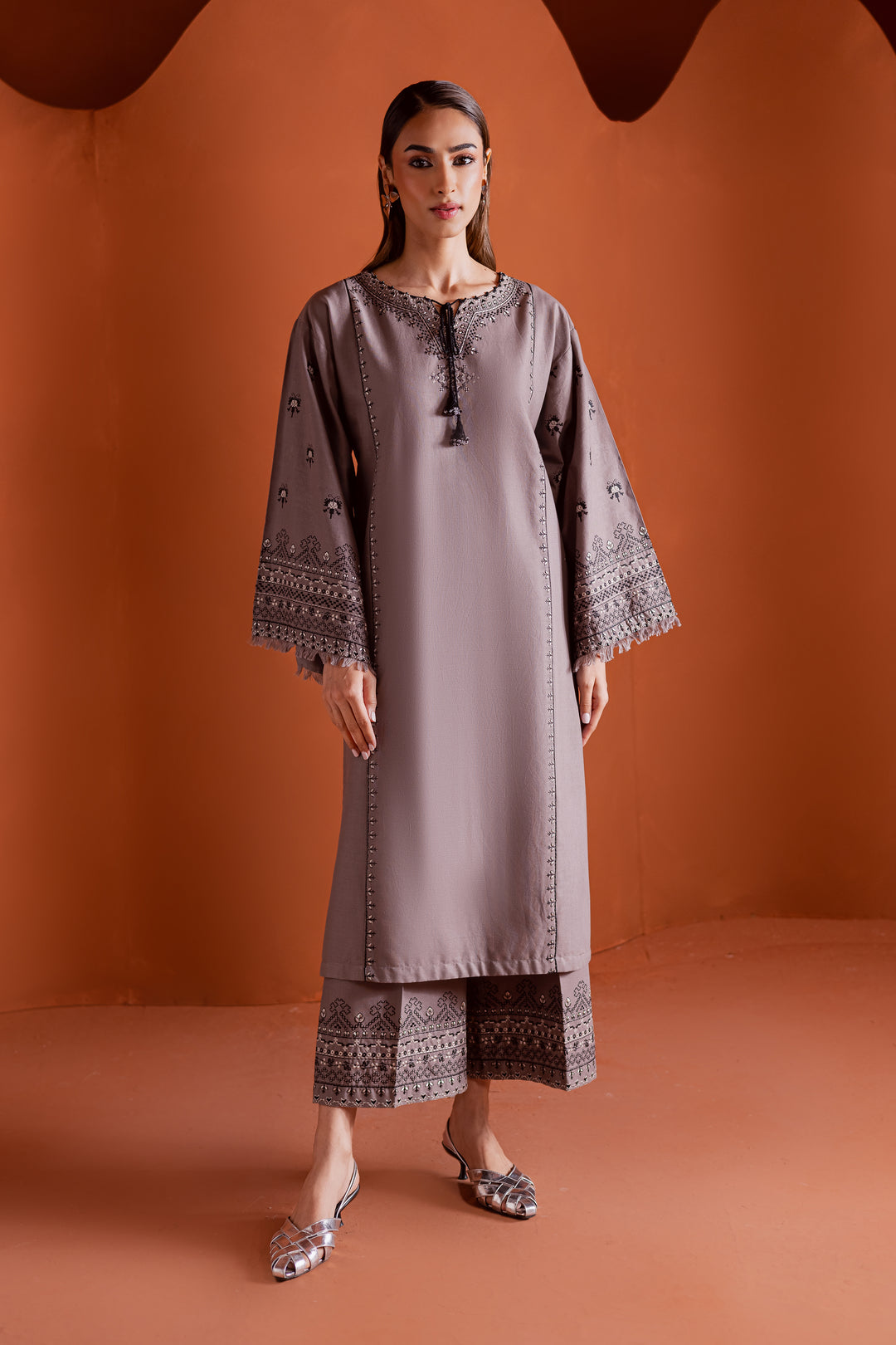 Batik UAE Crossword two piece khaddar set featuring a drop shoulder paneled shirt with cross stitch embroidery tassel neckline and fringed sleeves. Affordable ethnic South Asian Desi Indian Pakistani designer wear UAE fashion for teens adults girls and women.