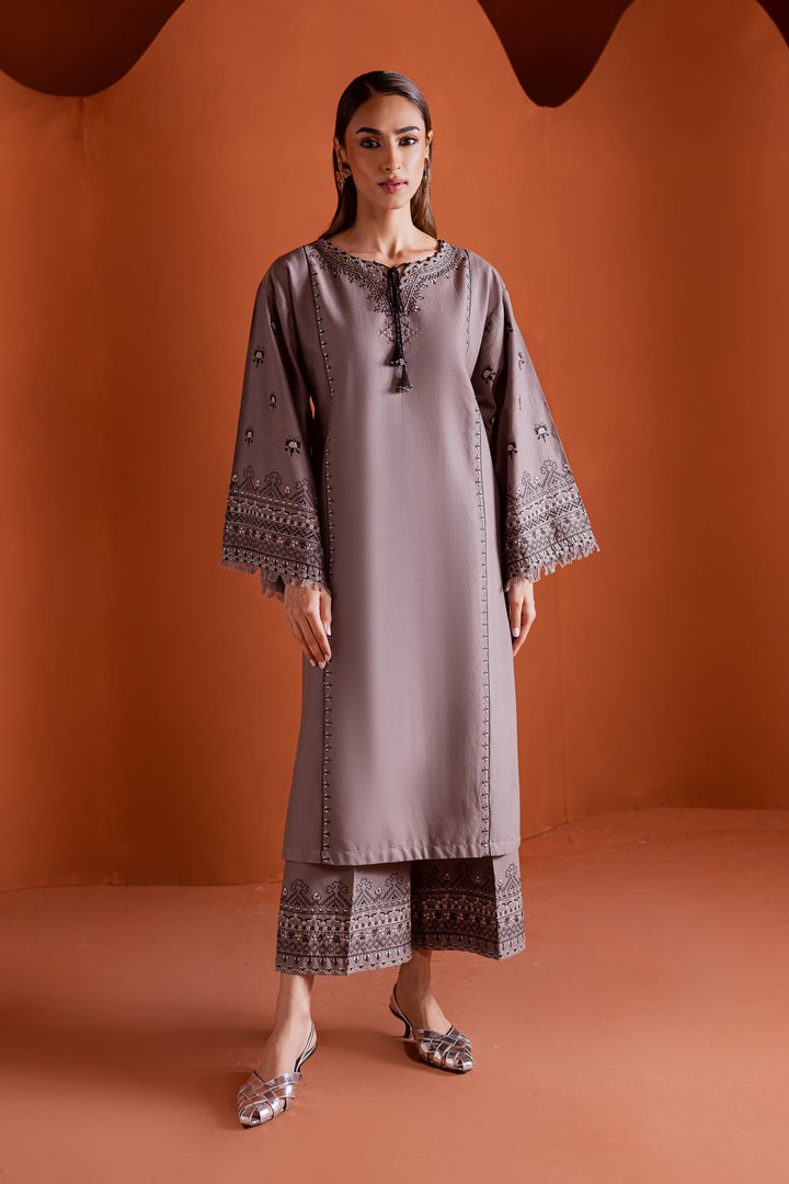 Batik UAE Crossword two piece khaddar set featuring a drop shoulder paneled shirt with cross stitch embroidery tassel neckline and fringed sleeves. Affordable ethnic South Asian Desi Indian Pakistani designer wear UAE fashion for teens adults girls and women.