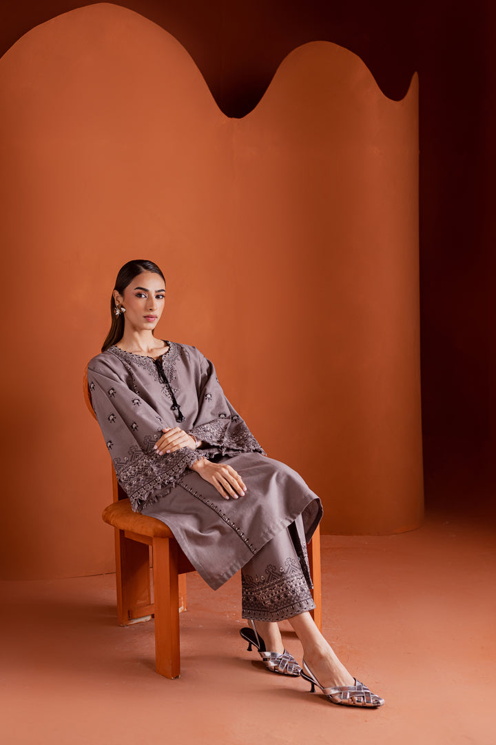 Batik UAE Crossword two piece khaddar set featuring a drop shoulder paneled shirt with cross stitch embroidery tassel neckline and fringed sleeves. Affordable ethnic South Asian Desi Indian Pakistani designer wear UAE fashion for teens adults girls and women.