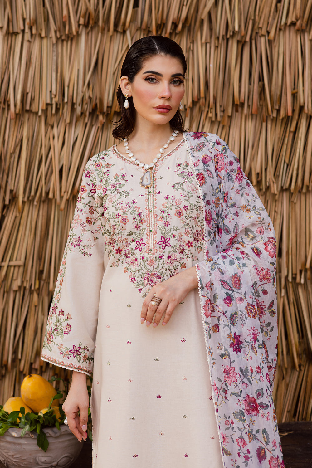 Elegant embroidered khaddar outfit with long beige shirt and pastel printed dupatta, ideal for South Asian festive fashion