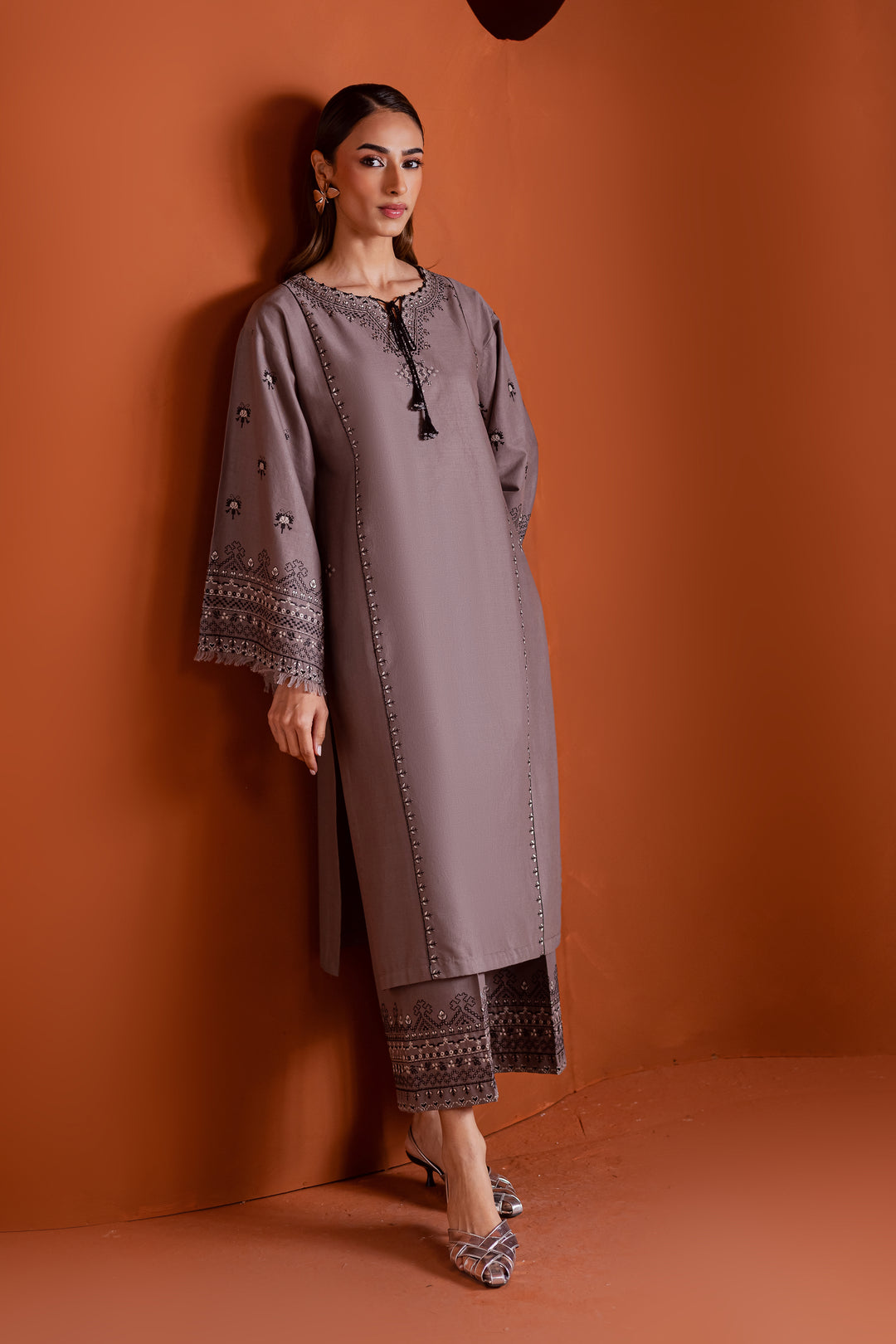 Batik UAE Crossword two piece khaddar set featuring a drop shoulder paneled shirt with cross stitch embroidery tassel neckline and fringed sleeves. Affordable ethnic South Asian Desi Indian Pakistani designer wear UAE fashion for teens adults girls and women.