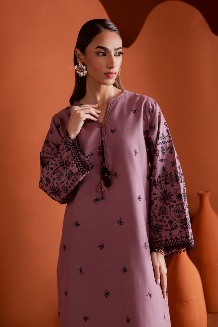 detailed view of Pakistani khaddar shirt with embroidered motifs and handcrafted tassel neckline in soft pink tones. Modern ethnic outfit from Batik’s stitched collection - elegant, affordable, and available online with global shipping