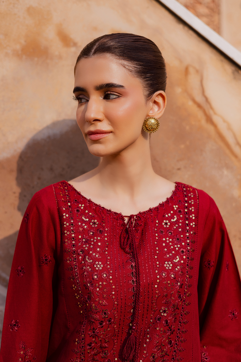 Batik UAE two piece khaddar set featuring a heavily embroidered shirt with boring work tassel embellishments and kabua finished sleeves paired with embroidered khaddar culottes. Affordable ethnic South Asian Desi Indian Pakistani designer wear UAE fashion for teens adults girls and women available in sizes XS S M L XL.