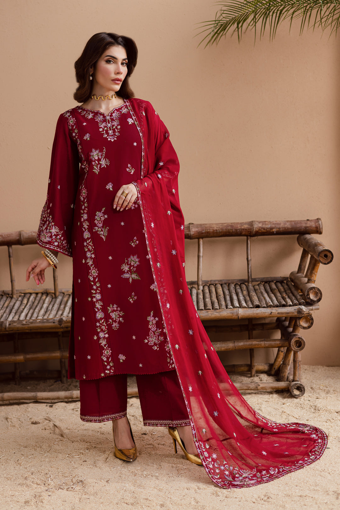 Beetroot red embroidered khaddar 3 piece suit with lace detailing and matching crinkle dupatta. Elegant Pakistani festive wear available with global delivery.