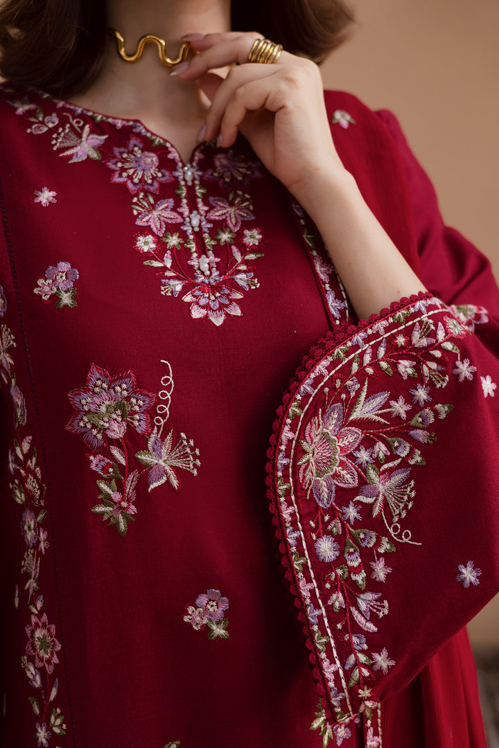 Close up of model wearing beetroot red embroidered 3 piece outfit. Premium Pakistani clothing with worldwide shipping and affordable prices