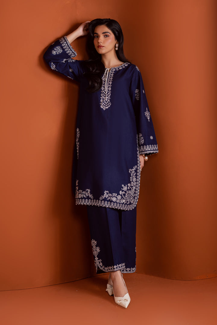 Radiate effortless charm with the Bloom two-piece set, featuring a beautifully composed embroidered midnight blue khaddar shirt that brings elegance due to every detail. The neckline is accented with delicate embroidered tassels, adding a playful yet refined touch.

Paired with matching khaddar culottes, this ensemble offers a graceful and modern silhouette—perfect for daytime festivities or casual gatherings.