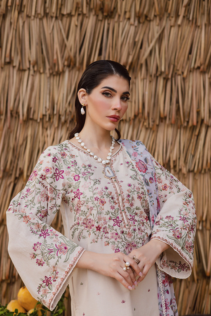 Close-up detail of intricate embroidery and beadwork on beige khaddar fabric, highlighting South Asian artisanal finesse