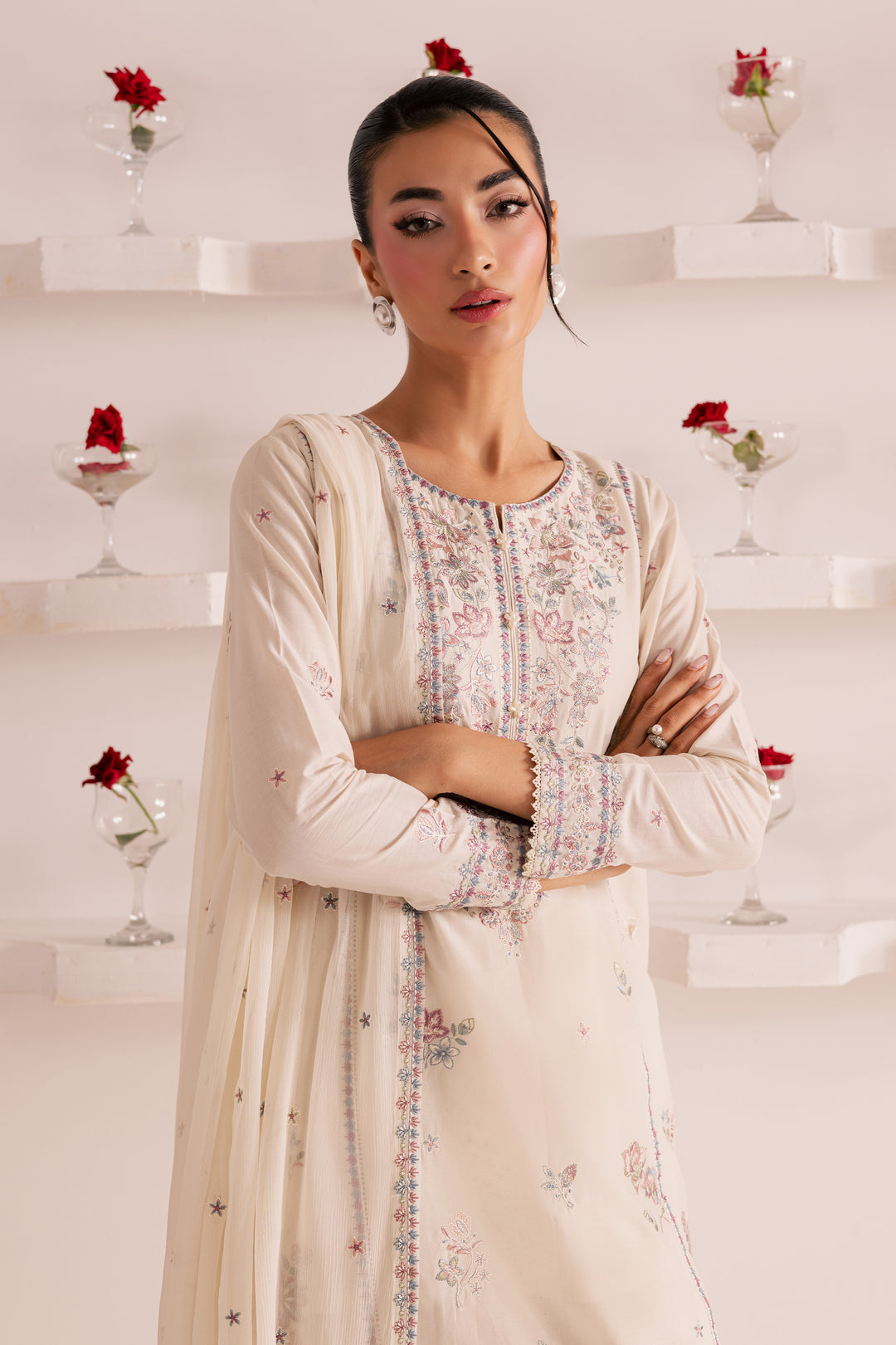Traditional South Asian embroidered outfit for women in soft ivory -Pakistani ethnic wear with pastel floral embroidery, chiffon dupatta, and cotton trousers. Ideal for Eid, parties, or semi-formal events. Easy delivery across UAE and worldwide