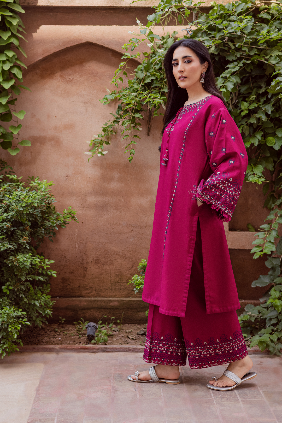 Batik UAE Crossword two piece khaddar set featuring a paneled shirt with cross stitch embroidery, tassel neckline, and fringed sleeves. Affordable ethnic South Asian Desi Indian Pakistani designer wear UAE fashion for teens, adults, girls, and women.