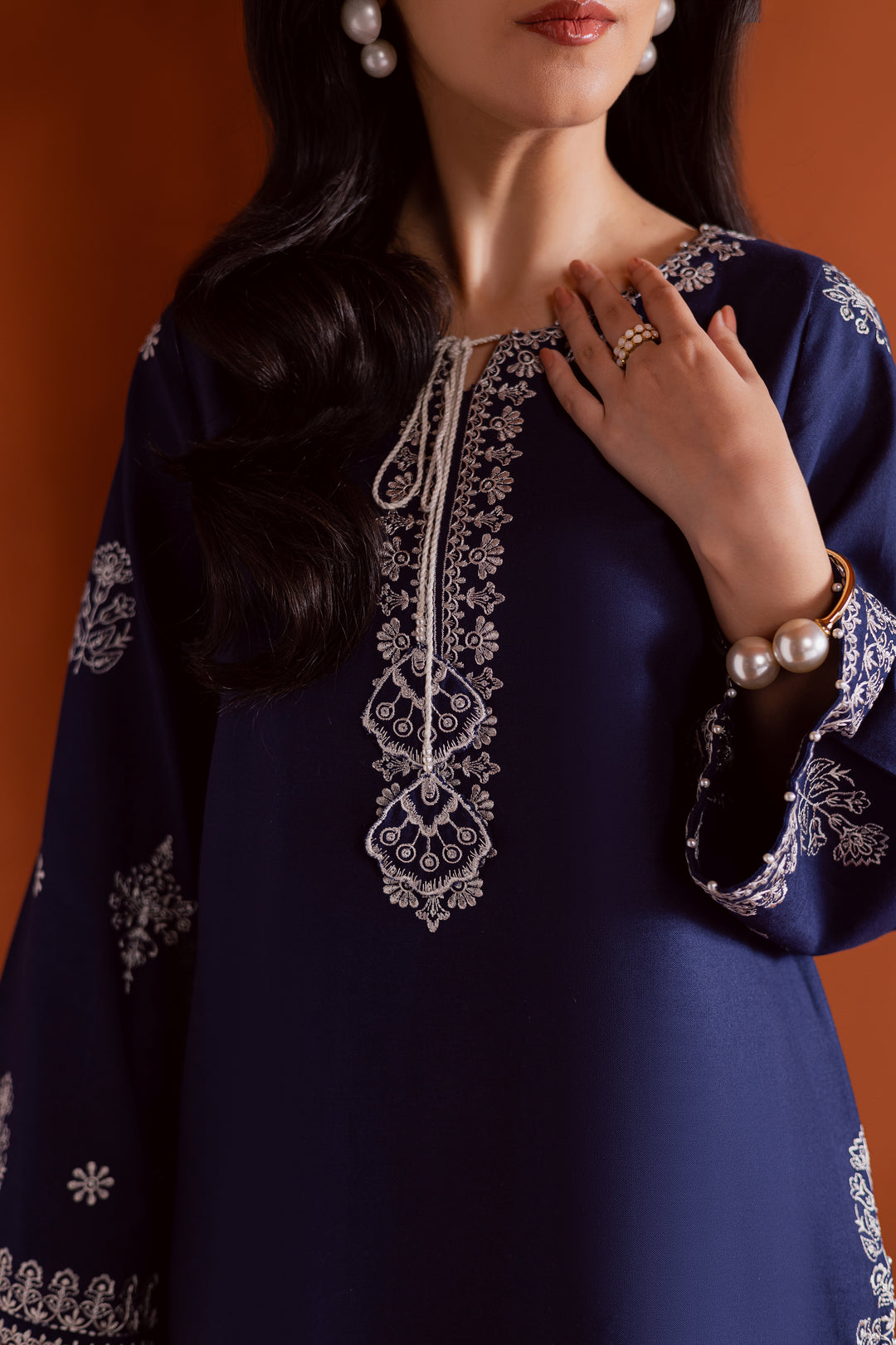 Radiate effortless charm with the Bloom two-piece set, featuring a beautifully composed embroidered midnight blue khaddar shirt that brings elegance due to every detail. The neckline is accented with delicate embroidered tassels, adding a playful yet refined touch.

Paired with matching khaddar culottes, this ensemble offers a graceful and modern silhouette—perfect for daytime festivities or casual gatherings.